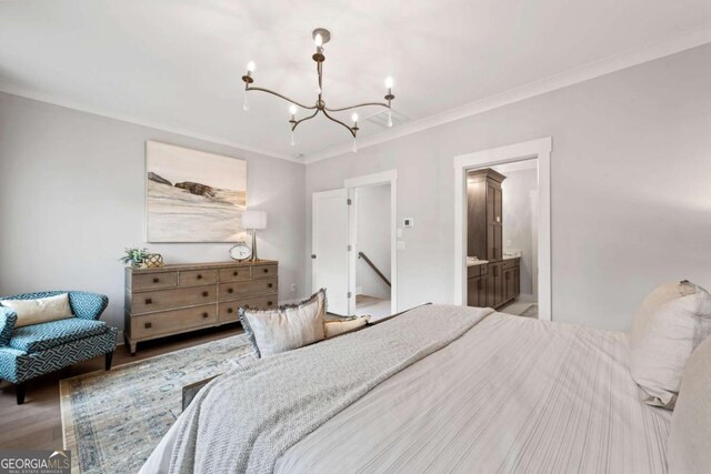bedroom with light wood-type flooring, ensuite bathroom, an inviting chandelier, and crown molding