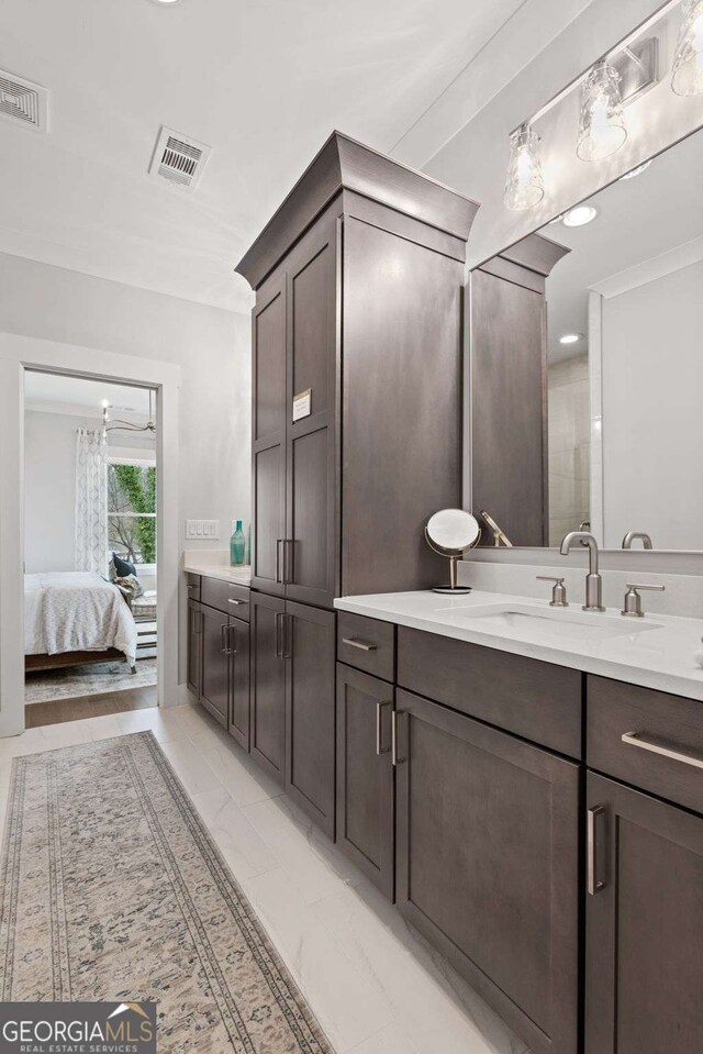 full bath with ensuite bathroom, vanity, and visible vents