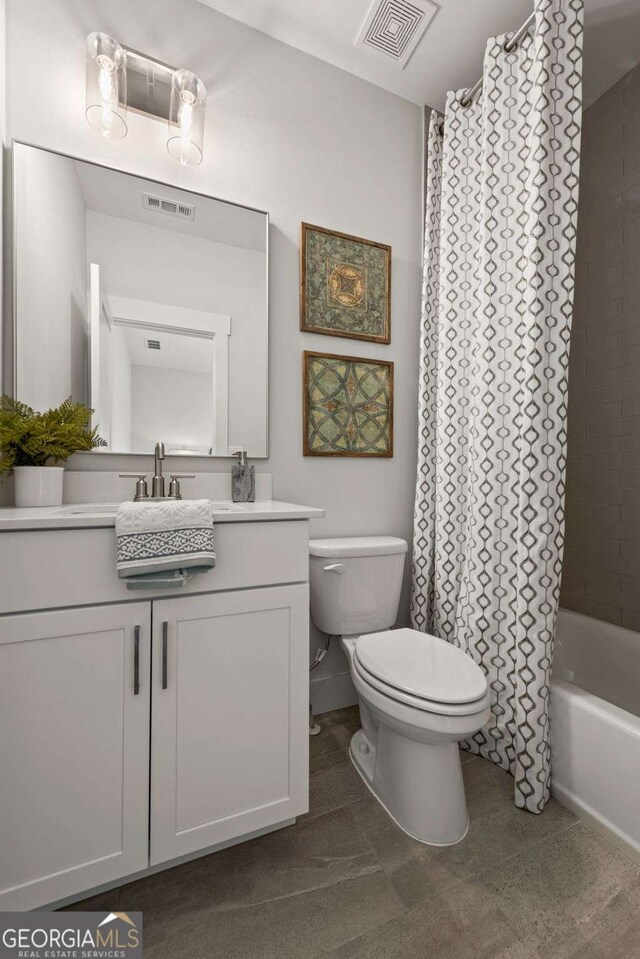 bathroom with toilet, visible vents, and vanity