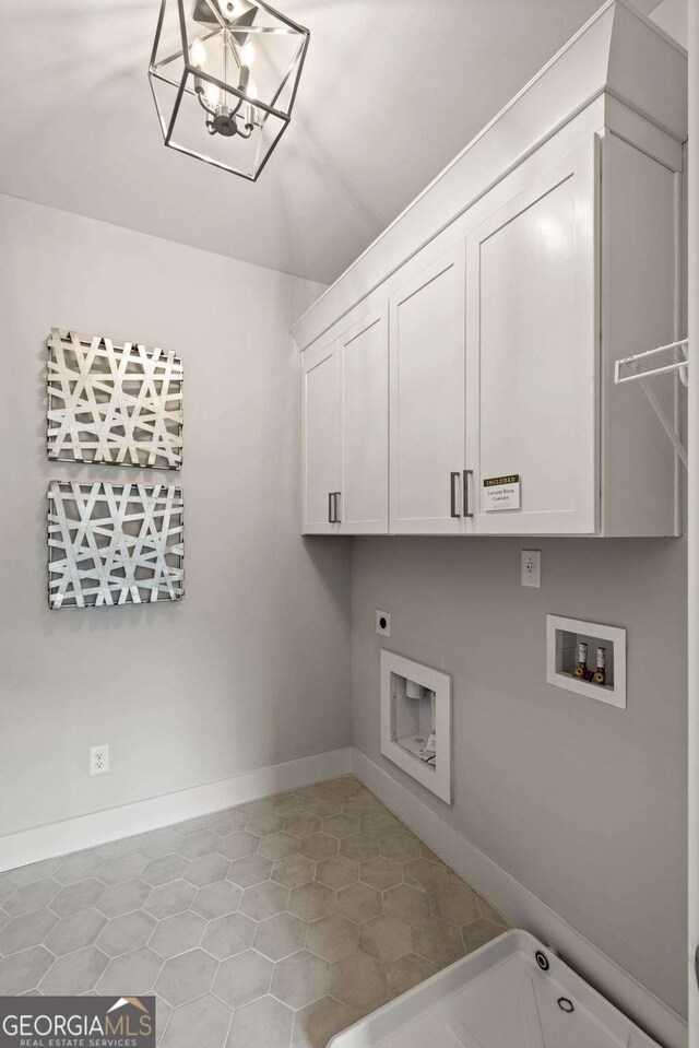 washroom featuring baseboards, hookup for a washing machine, tile patterned flooring, hookup for an electric dryer, and cabinet space