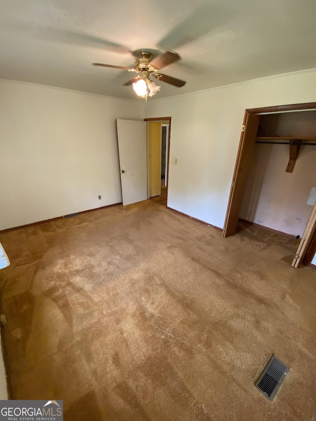 unfurnished bedroom featuring carpet flooring and ceiling fan