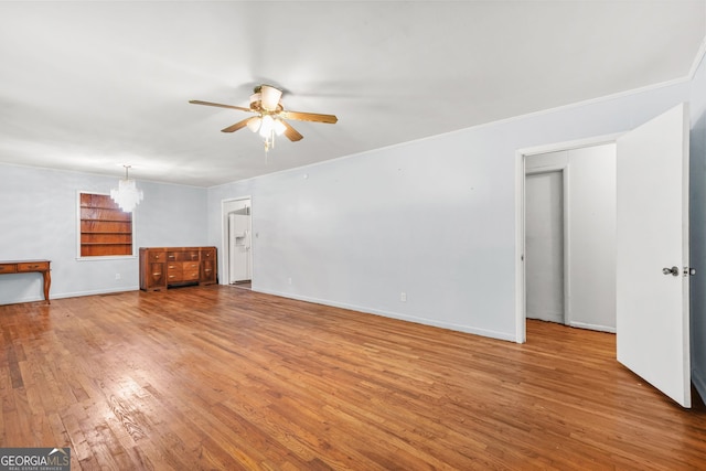 119 Blount St, Forsyth, GA 31029 - unfurnished living room with a ceiling fan, hardwood / wood-style floors, a chandelier, and crown molding