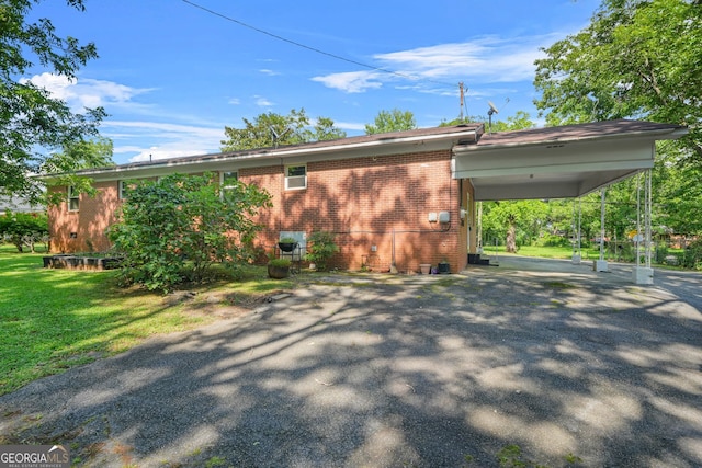 119 Blount St, Forsyth, GA 31029 - view of home's exterior featuring brick siding, driveway, and a yard