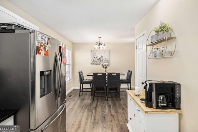 7760 Poppy Dr, Winston, GA 30187 - dining room featuring baseboards, a notable chandelier, and wood finished floors