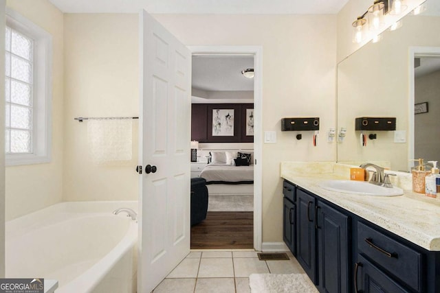 7760 Poppy Dr, Winston, GA 30187 - bathroom featuring tile patterned flooring, connected bathroom, a garden tub, and plenty of natural light
