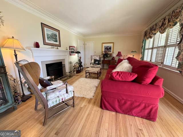 living room with baseboards, a fireplace with flush hearth, crown molding, and wood finished floors