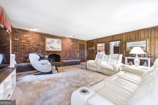 living room with a brick fireplace, wood walls, and carpet
