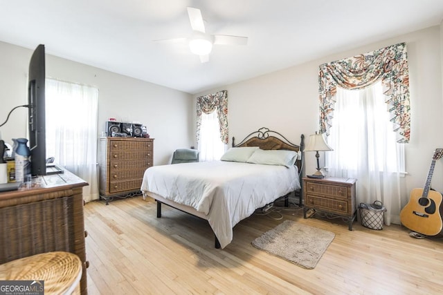 bedroom with ceiling fan and light wood-style flooring