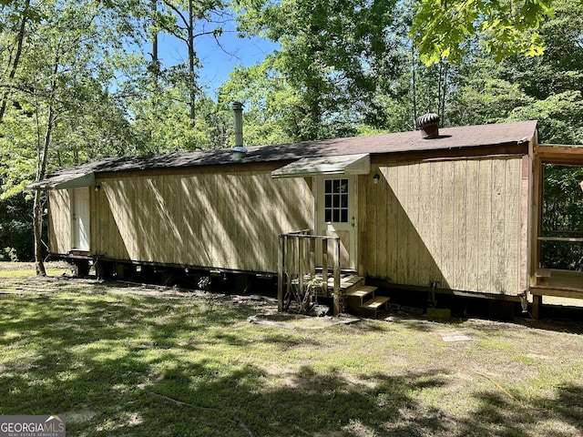 view of side of property with a lawn