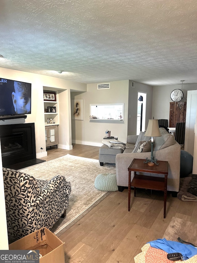 506 Park Ridge Cir, Marietta, GA 30068 - living room featuring a textured ceiling, hardwood / wood-style flooring, and baseboards