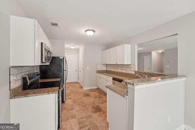kitchen with stainless steel appliances, white cabinetry, visible vents, light stone countertops, and decorative backsplash