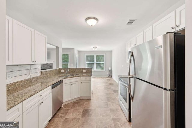 kitchen featuring white cabinetry, visible vents, appliances with stainless steel finishes, and a sink