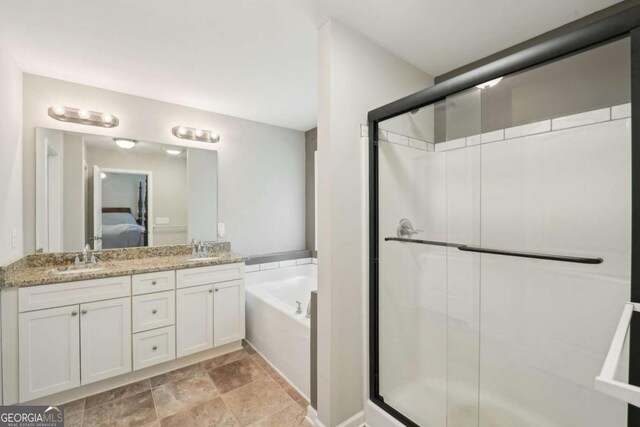 bathroom featuring a shower stall, ensuite bathroom, a sink, and a bath