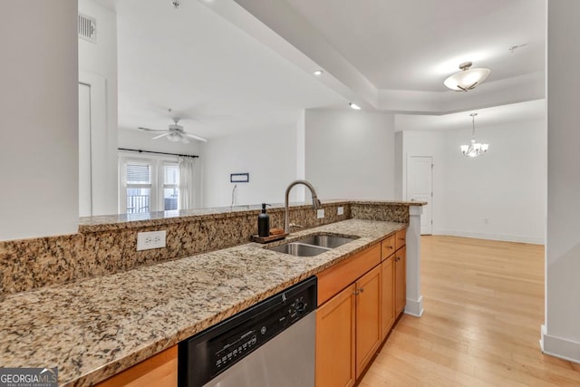 kitchen featuring ceiling fan with notable chandelier, a sink, stainless steel dishwasher, visible vents, and light stone counters