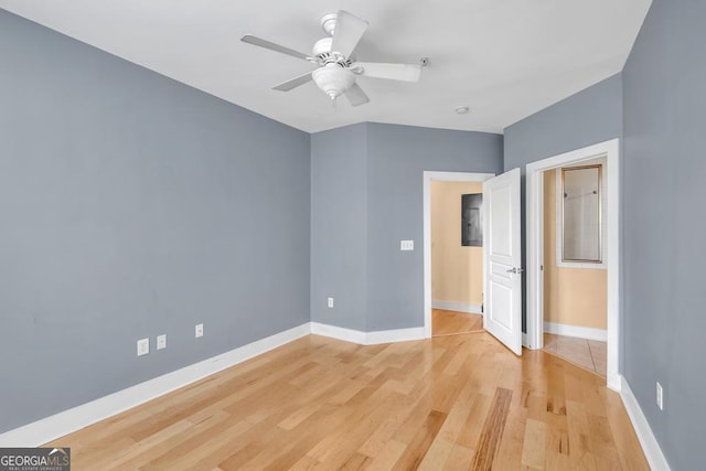 unfurnished bedroom with ceiling fan, baseboards, and light wood-style floors