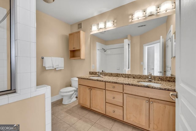 full bathroom with tiled shower, tile patterned floors, visible vents, and a sink