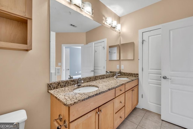 full bath with tile patterned floors, toilet, visible vents, and a sink