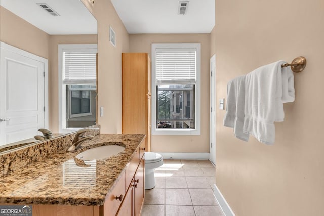bathroom featuring vanity, toilet, baseboards, and visible vents
