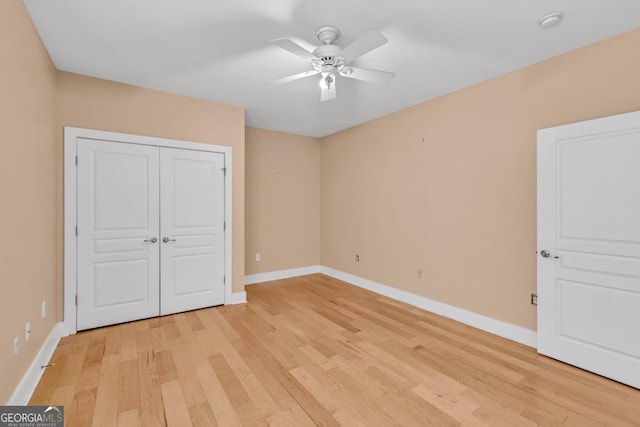 unfurnished bedroom featuring light wood finished floors, ceiling fan, baseboards, and a closet