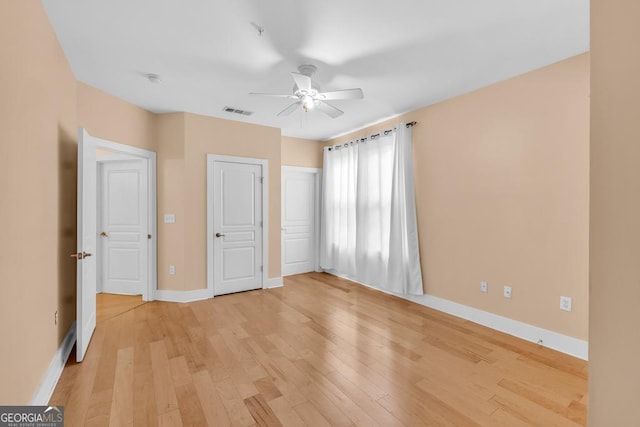 unfurnished bedroom with light wood-type flooring, visible vents, and baseboards