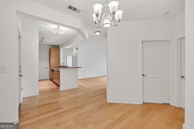 kitchen featuring visible vents, an inviting chandelier, hanging light fixtures, baseboards, and light wood-style floors