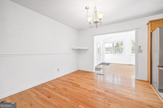 303 Jennys Cove Rd, Cleveland, GA 30528 - unfurnished dining area with baseboards, a notable chandelier, and light wood finished floors