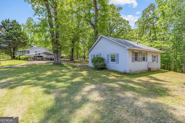 303 Jennys Cove Rd, Cleveland, GA 30528 - view of side of property featuring a carport and a lawn