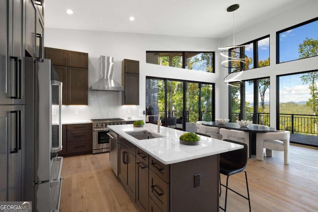 714 Scouts Overlook, Morganton, GA 30560 - kitchen with a sink, stainless steel appliances, wall chimney range hood, and plenty of natural light