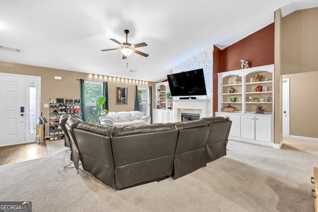 1553 Shoal Creek Dr, Winder, GA 30680 - living room with ceiling fan, lofted ceiling, a large fireplace, and light colored carpet
