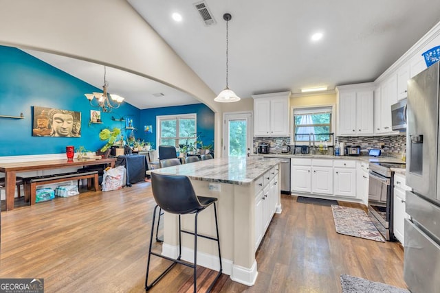 1553 Shoal Creek Dr, Winder, GA 30680 - kitchen featuring stainless steel appliances, tasteful backsplash, white cabinetry, a kitchen island, and recessed lighting