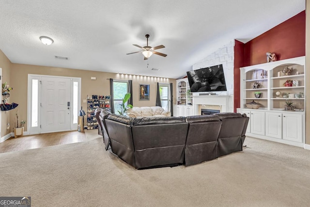 1553 Shoal Creek Dr, Winder, GA 30680 - living room featuring light colored carpet, ceiling fan, a fireplace, and vaulted ceiling