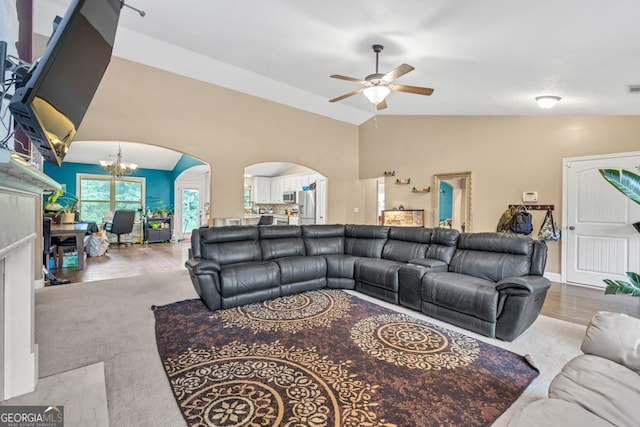 1553 Shoal Creek Dr, Winder, GA 30680 - living area featuring arched walkways, ceiling fan, vaulted ceiling, and a chandelier