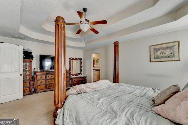 bedroom with a raised ceiling, carpet flooring, a textured ceiling, a ceiling fan, and ornamental molding