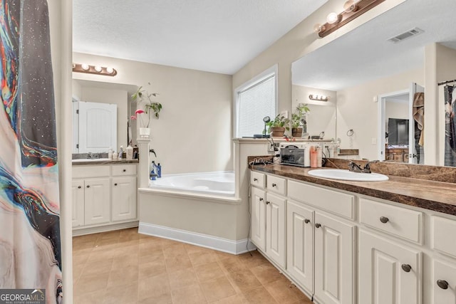1553 Shoal Creek Dr, Winder, GA 30680 - full bath featuring vanity, a garden tub, and tile patterned floors
