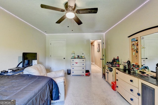 bedroom with light carpet and ceiling fan