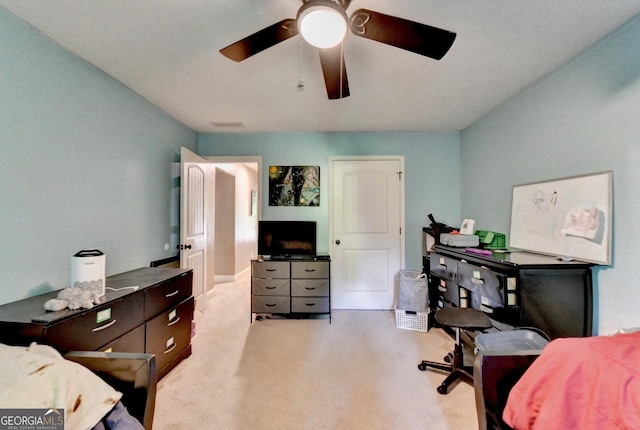 bedroom with light carpet and a ceiling fan