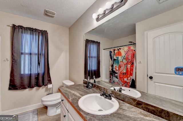 full bath featuring vanity, toilet, tile patterned floors, a textured ceiling, and curtained shower