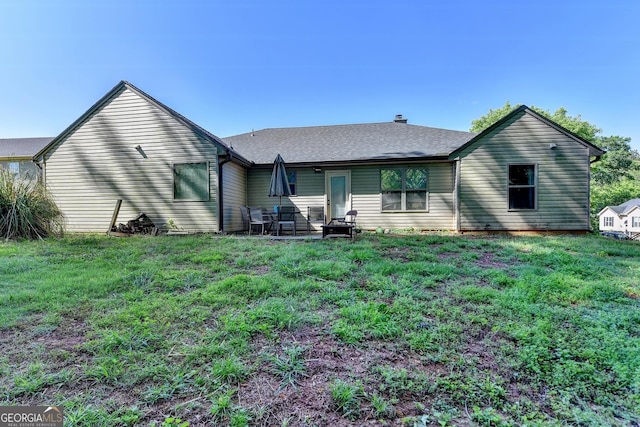 back of property featuring a lawn and a patio area