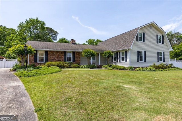 540 Commanche Dr, Macon, GA 31210 - view of front of house with a front lawn, fence, roof with shingles, and a chimney