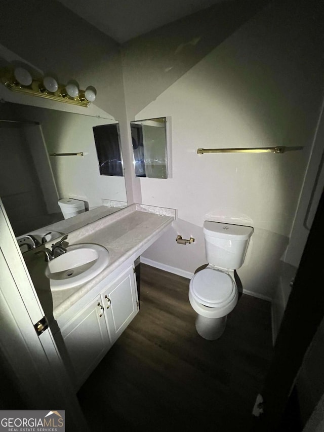 2572 Stratford Ln, Morrow, GA 30260 - bathroom featuring vanity, toilet, baseboards, and wood finished floors