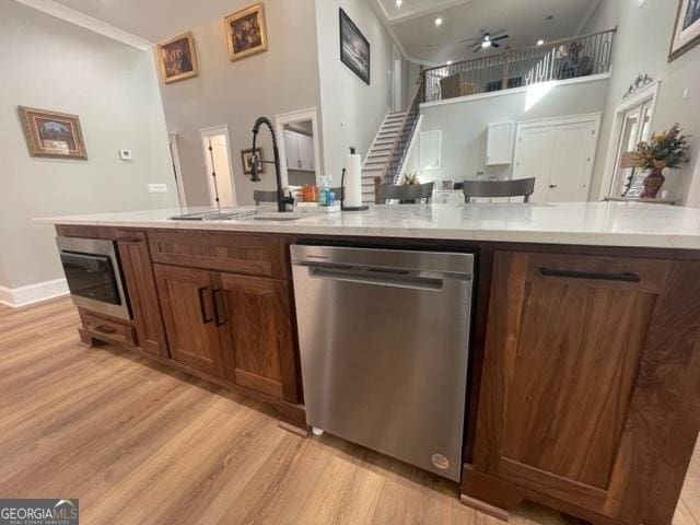 338 Grady St, Waleska, GA 30183 - kitchen with appliances with stainless steel finishes, light wood-type flooring, a high ceiling, light countertops, and a ceiling fan