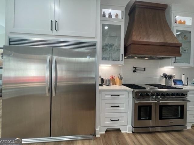 338 Grady St, Waleska, GA 30183 - kitchen with stainless steel appliances, custom range hood, wood finished floors, and light countertops