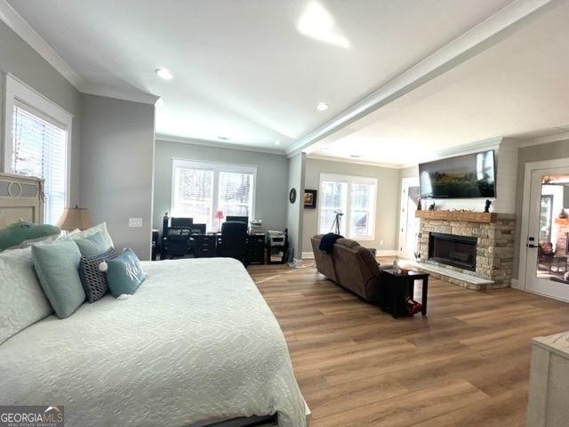 338 Grady St, Waleska, GA 30183 - bedroom with crown molding, a stone fireplace, wood finished floors, multiple windows, and recessed lighting