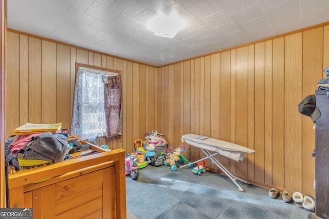 carpeted bedroom with wood walls
