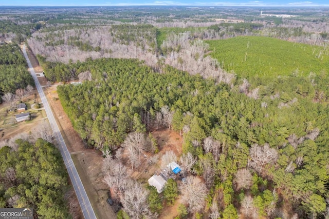 birds eye view of property with a view of trees
