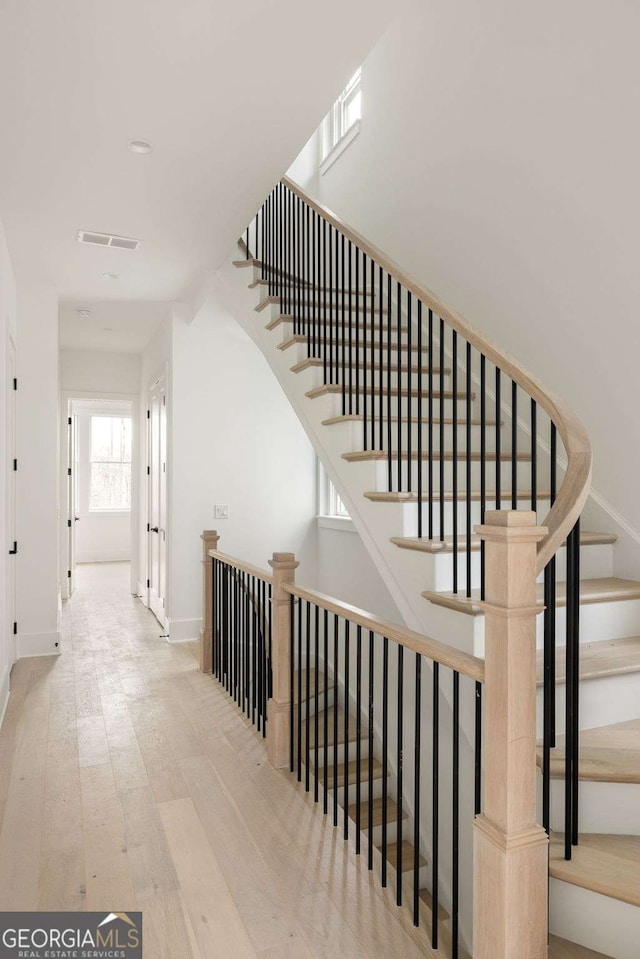 11536 Serenbe Ln, Chattahoochee Hills, GA 30268 - stairway with baseboards, visible vents, and wood finished floors