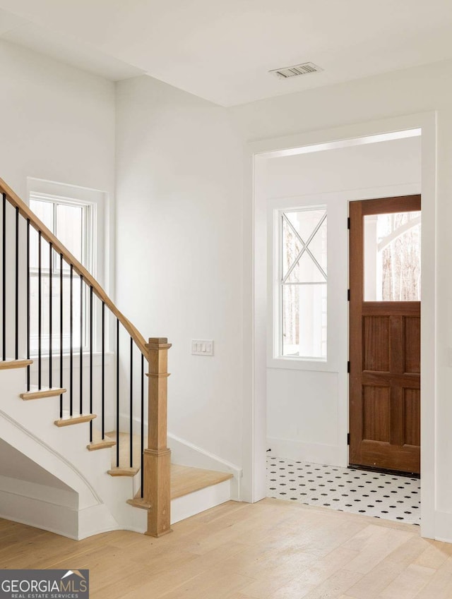 11536 Serenbe Ln, Chattahoochee Hills, GA 30268 - foyer entrance with baseboards, stairway, visible vents, and wood finished floors