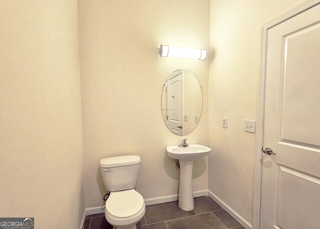 870 Mayson Turner Rd NW Unit 1447, Atlanta, GA 30314 - half bath featuring tile patterned floors, baseboards, toilet, and a sink