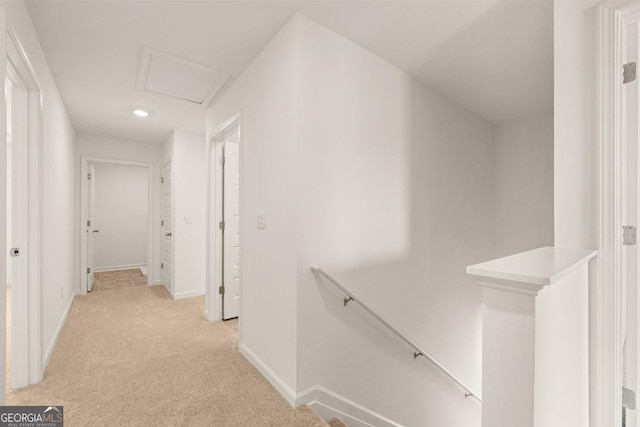 hall with light colored carpet, an upstairs landing, baseboards, and recessed lighting
