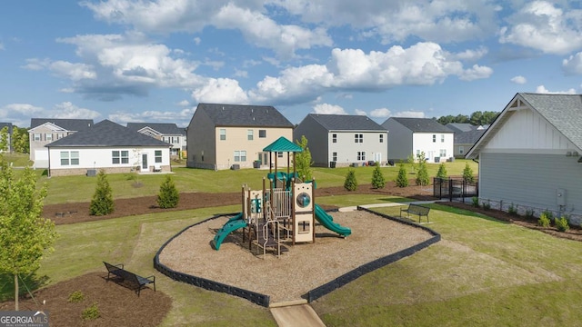 view of jungle gym featuring a yard and a residential view